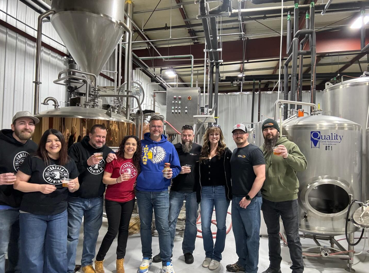 A group of brewery owners from Mikerphone Brewing, Torzala Brewing and Steel Tank Brewing pose for a photo after creating a new beer together that celebrates Mukwonago, the hometown of the owners of each brewery.