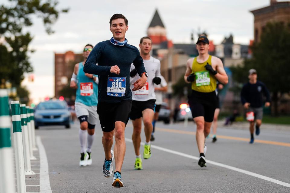 Runners make their way through Midtown Detroit during the 44th Annual Detroit Free Press Marathon in October 2021.