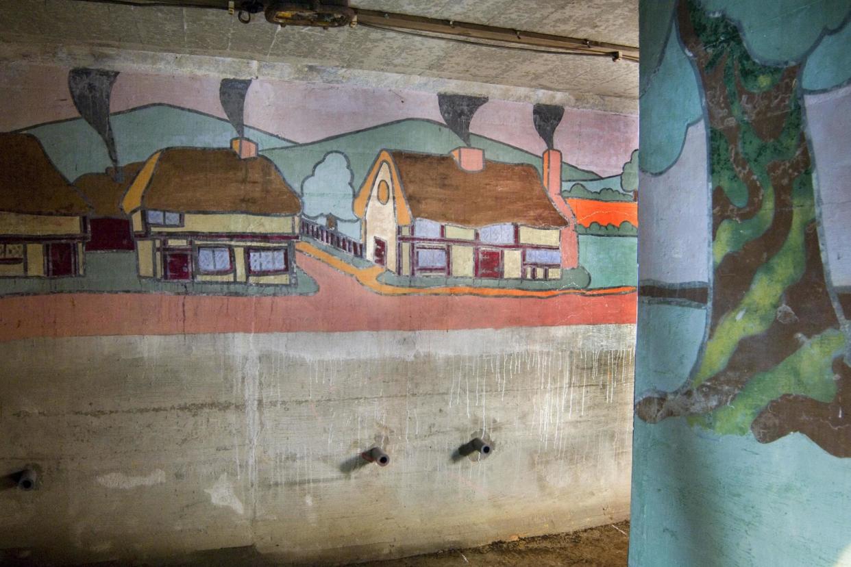 An air raid shelter featuring a set of colourful murals depicting scenes from various literary tales at St John's Primary School in Redhill, Surrey: PA