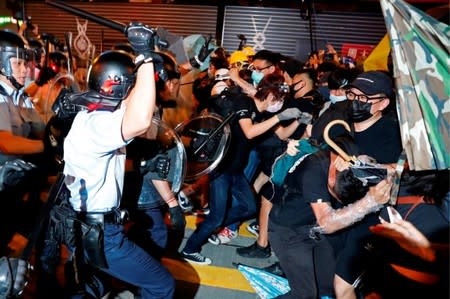 Riot police try to disperse anti-extradition bill protesters after a march at Hong Kong's tourism district Nathan Road near Mongkok