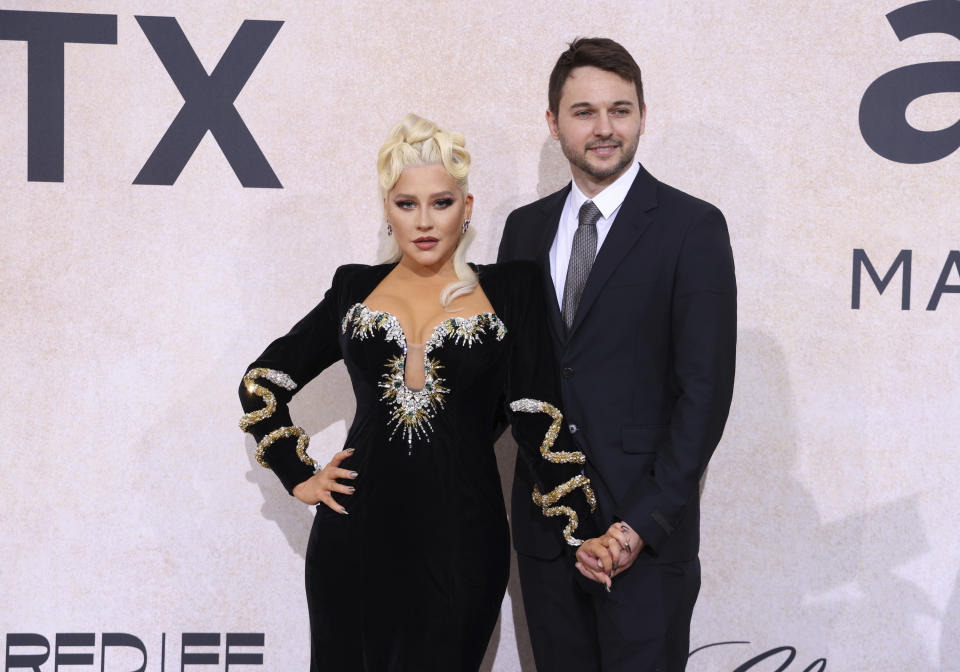 Christina Aguilera, left, and Matthew Rutler pose for photographers upon arrival at the amfAR Cinema Against AIDS benefit at the Hotel du Cap-Eden-Roc, during the 75th Cannes international film festival, Cap d'Antibes, southern France, Thursday, May 26, 2022. (Photo by Vianney Le Caer/Invision/AP)