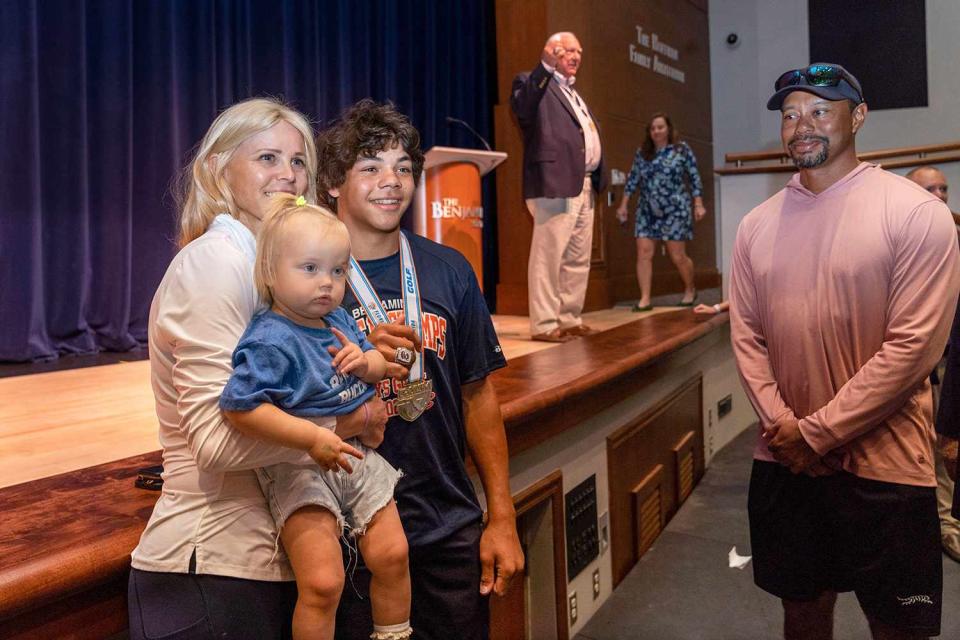 <p>Greg Lovet/The Palm Beach Post/USA Today Network</p> Elin Nordegren holds her toddler while posing with son Charlie