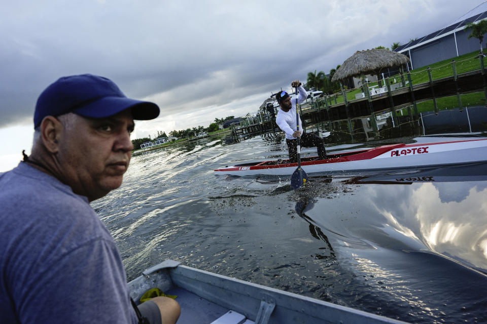 Fernando Dayan Jorge, right, paddles his canoe during a training session with coach Alain Nogueras, ahead of the 2024 Paris Olympics, Wednesday, June 26, 2024, in Cape Coral, Fla. Jorge, who will compete in canoe sprint for the Refugee Olympic Team, competed for his native country Cuba in the Rio 2016 and the Toyko 2020 Olympics. (AP Photo/Rebecca Blackwell)