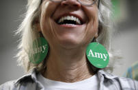 A supporter smiles while listening to Democratic presidential candidate Sen. Amy Klobuchar, D-Minn., at a campaign office, Saturday, Feb. 22, 2020, in Las Vegas. (AP Photo/John Locher)