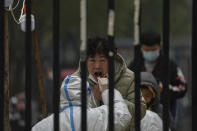 FILE - A woman has her routine COVID-19 test at a coronavirus testing site setup inside a residential compound in Beijing, Thursday, Nov. 24, 2022. (AP Photo/Andy Wong, File)