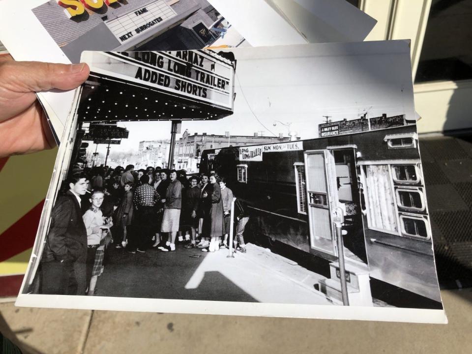 Monday, July 13, 2020 Sun Theatre Owner Chuck Pantera holds up a black and white photograph taken outside several decades ago. The downtown Grand Ledge theater is nearly a century old.