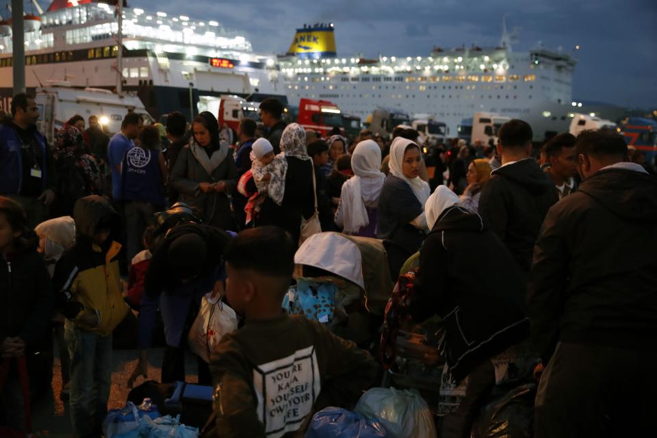 Migrants and refugees arrive from Lesbos island to the port of Piraeus, near Athens, Monday Oct. 7, 2019. In the last 24 hours 668 refugees and migrants have been transferred to mainland Greece from five Greek islands as authorities have accelerated efforts to ease over crowding in the camps. (AP Photo/Thanassis Stavrakis)