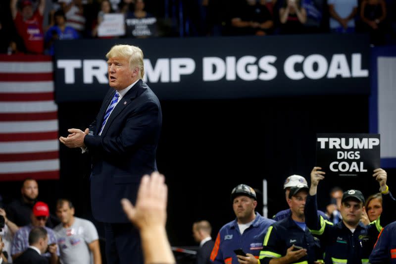 FILE PHOTO: U.S. President Donald Trump acknowledges coal miners during a Make America Great Again rally at the Civic Center in Charleston