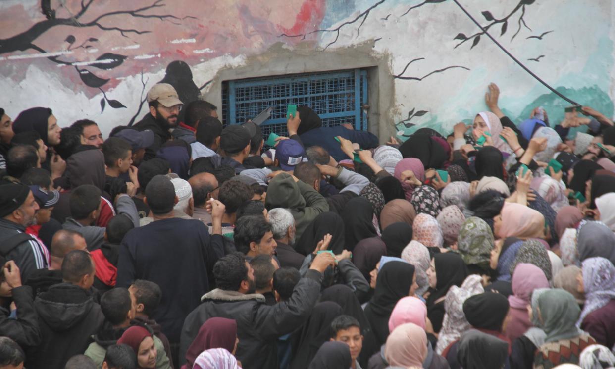 <span>Palestinians wait in front of the UN Relief and Works Agency for Palestine Refugees in the Near East (Unrwa) distribution centre on 18 March.</span><span>Photograph: Anadolu/Getty Images</span>