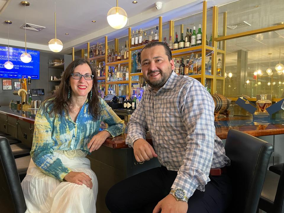 Lohud Food & Dining Reporter Jeanne Muchnick with Dive Oyster House Owner Kenny Neziraj against the backdrop of the restaurant's ocean-themed bar. Photographed May 2024