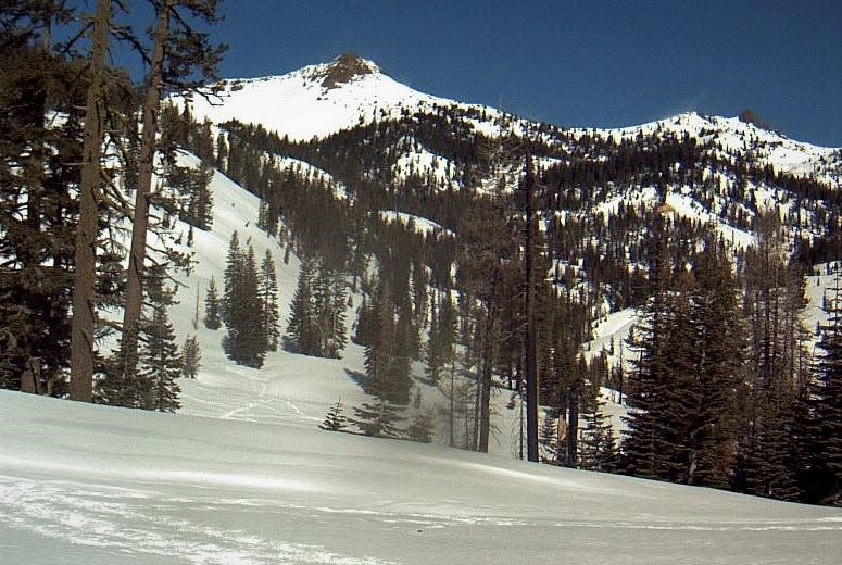 This image was taken from the Lassen Volcanic National Park webcam, looking north from the Kohm Yah-mah-nee Visitor Center.  The peak to the left is Mt. Diller and Pilot Pinnacle to the right. The dark smudge in the middle foreground of the photo is steam rising from the Sulphur Works hydrothermal area.