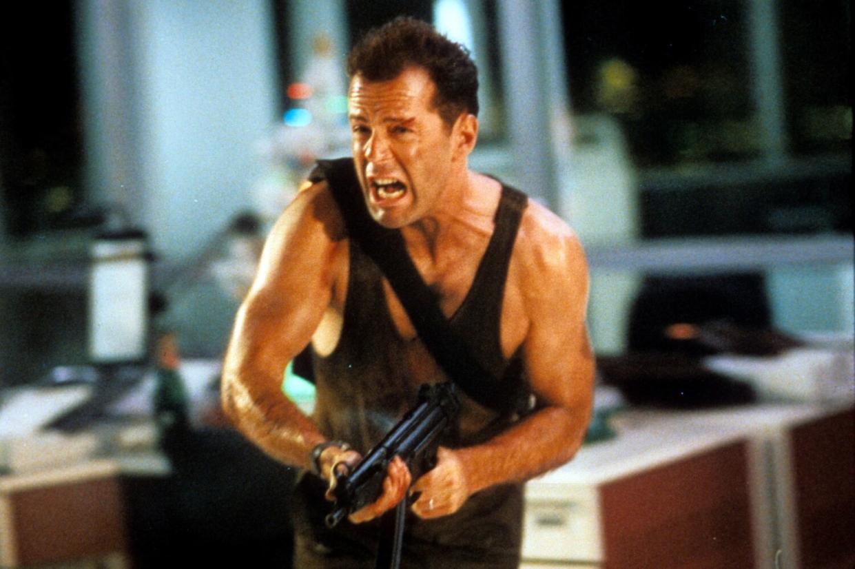 Bruce Willis running with automatic weapon in a scene from the movie "Die Hard" (1988).