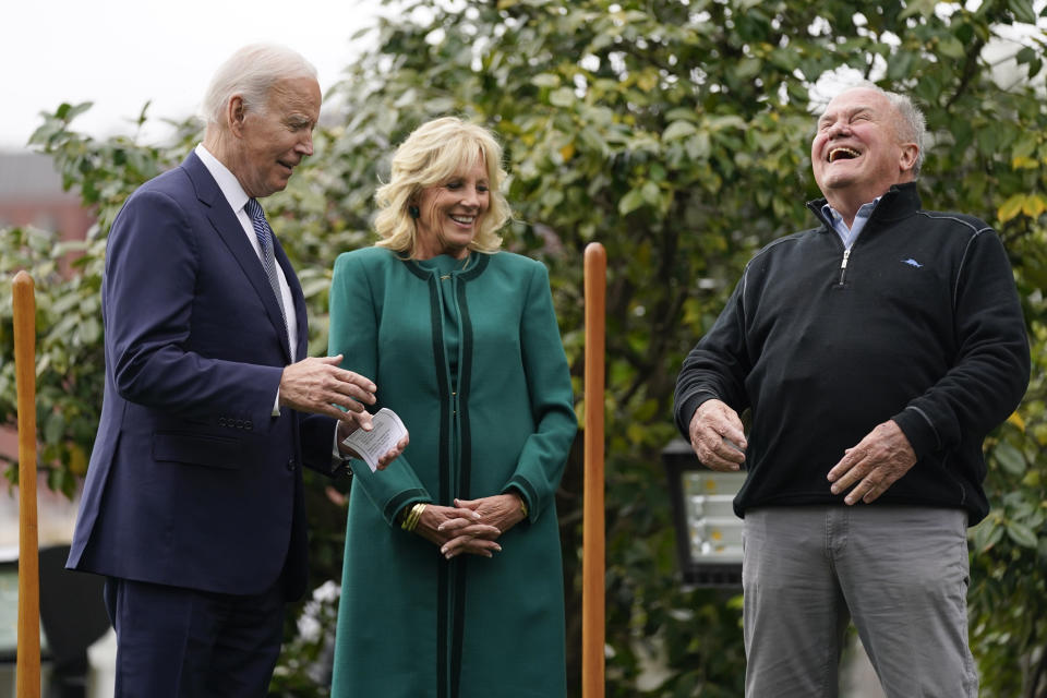 Dale Haney, the chief White House groundskeeper, right, laughs as he stands with President Joe Biden and first lady Jill Biden during a tree planting ceremony on the South Lawn of the White House, Monday, Oct. 24, 2022, in Washington. As of this month, Haney has tended the lawns and gardens of the White House for 50 years. (AP Photo/Evan Vucci)