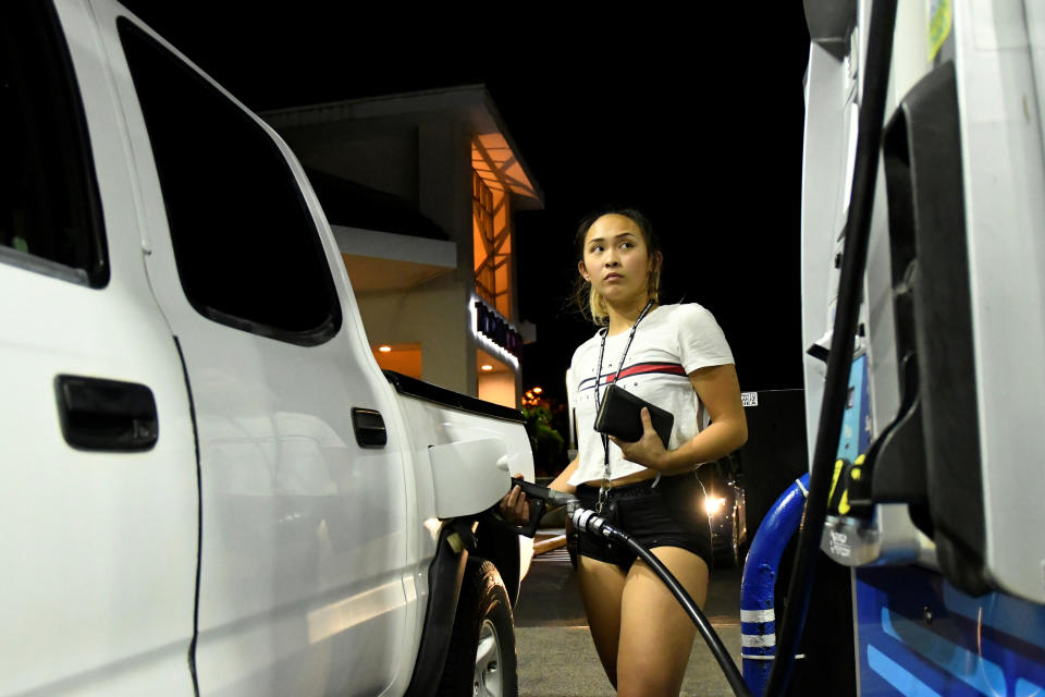 <p>Jaycee Sotello fills her truck up with gas as Hurricane Lane approaches Honolulu, Hawaii, Aug. 21, 2018. (Photo: Hugh Gentry/Reuters) </p>