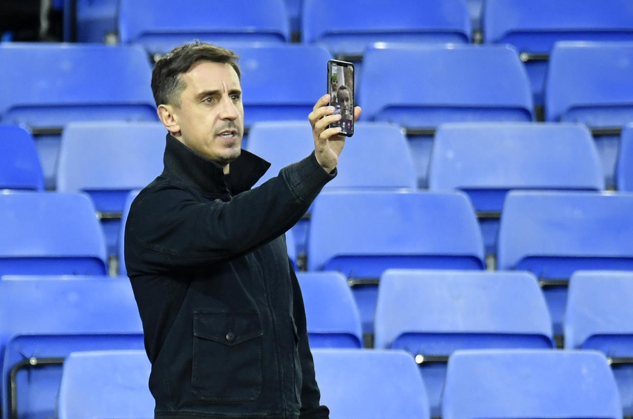 Gary Neville, part owner of Salford City is seen using his phone inside the stadium. (Getty)