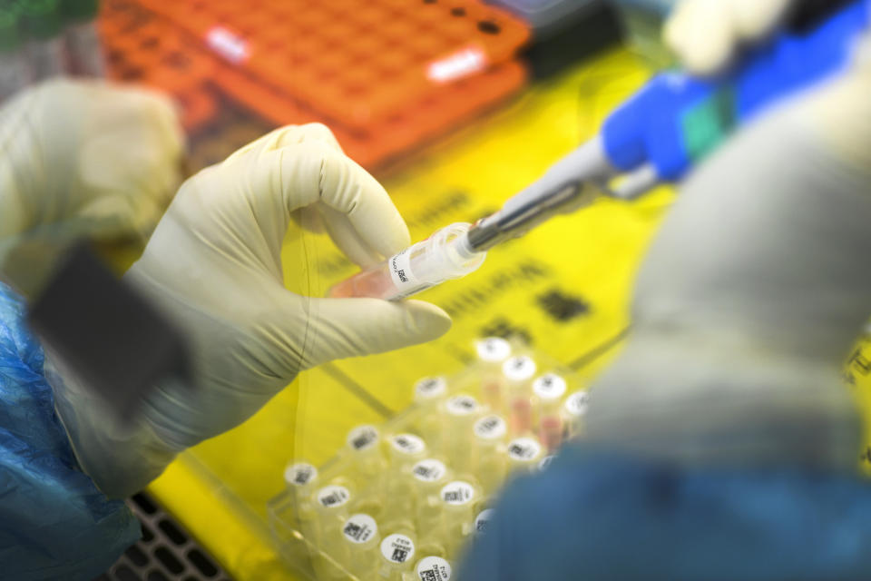 In this Thursday, Feb. 6, 2020, photo, an employee works in the pop-up Huoyan Laboratory specialized in the nucleic acid test on 2019-nCoV in Wuhan in central China's Hubei province. The coronavirus continues to spread as of Friday, Feb. 7, 2020, China reported more than 31,000 cases. (Chinatopix via AP)