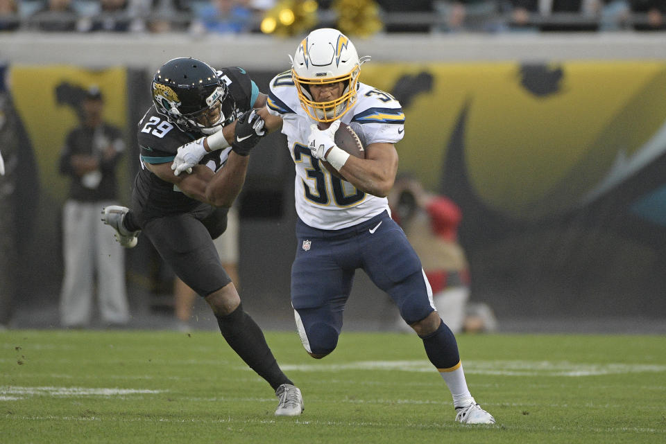 Los Angeles Chargers running back Austin Ekeler (30) runs for yardage past Jacksonville Jaguars safety Marcus Gilchrist, left, during the first half of an NFL football game, Sunday, Dec. 8, 2019, in Jacksonville, Fla. (AP Photo/Phelan M. Ebenhack)