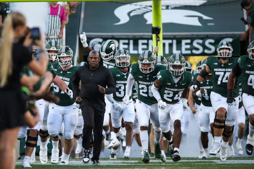 Michigan State head coach Mel Tucker runs out with the team before the Central Michigan game at Spartan Stadium in East Lansing on Friday, Sept. 1, 2023.