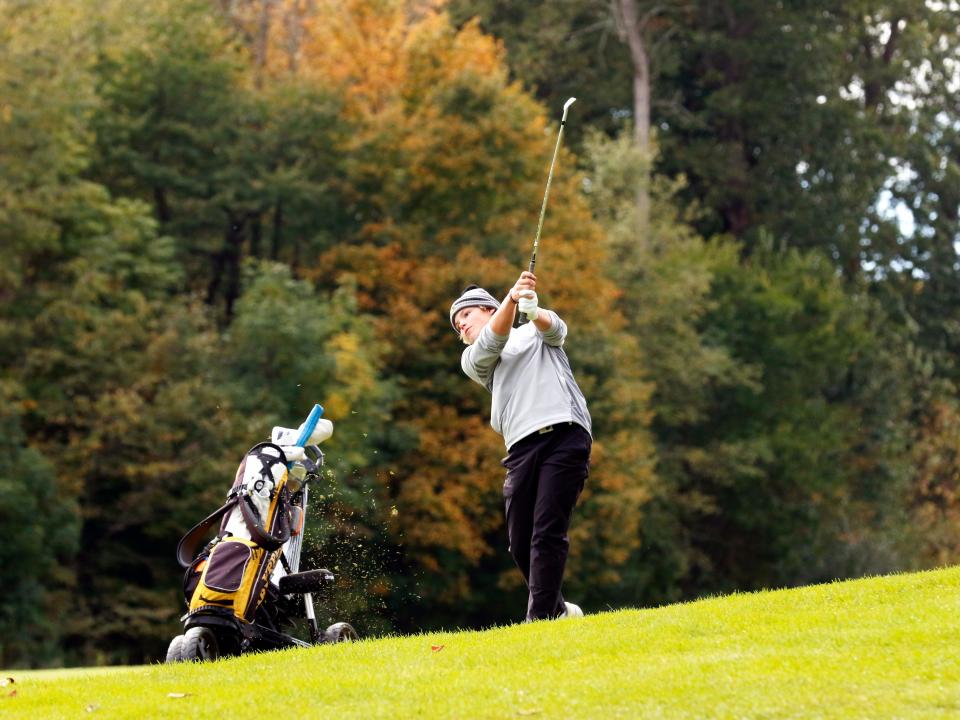 Upper Arlington's Bric Baird hits his approach shot on the par-4 No. 8 hole during the Division I district tournament Tuesday at Apple Valley.