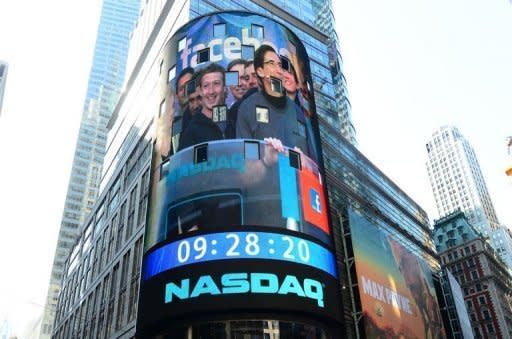 Facebook co-founder Mark Zukerberg is seen on a screen getting ready to ring the NASDAQ stock exchange opening bell in Times Square in New York