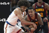 New York Knicks forward Jericho Sims (45) and Atlanta Hawks forward John Collins (20) battle for a loose ball during the first half of an NBA basketball game Saturday, Nov. 27, 2021, in Atlanta. (AP Photo/Hakim Wright Sr.)