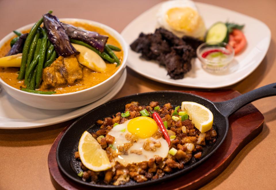 Kare Kare (left), pork sisig (center) and tapsilog from At My Place Cafe in Chandler.