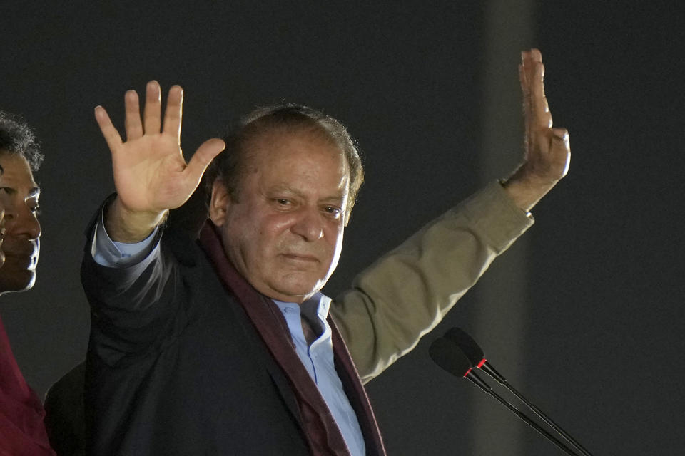 Pakistan's former Prime Minister Nawaz Sharif, center waves to his supporters upon his arrival to address a welcoming rally, in Lahore, Pakistan, Saturday, Oct. 21, 2023. Sharif returned home Saturday on a special flight from Dubai, ending four years of self-imposed exile in London as he seeks to win the support of voters ahead of parliamentary elections due in January. (AP Photo/Anjum Naveed)