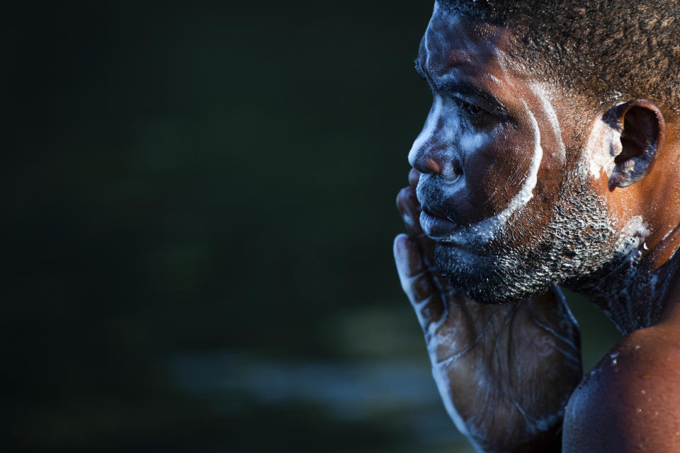 A man part of a group of migrating Haitians washes his face and hair early Friday, Sept. 17, 2021 in the Rio Grade in between Del Rio, Texas and Ciudad Acuña, Mexico. Haitians crossed the Rio Grande freely and in a steady stream, going back and forth between the U.S. and Mexico through knee-deep water with some parents carrying small children on their shoulders. Unable to buy supplies in the U.S., they returned briefly to Mexico for food and cardboard to settle, temporarily at least, under or near the bridge in Del Rio, a city of 35,000 that has been severely strained by migrant flows in recent months. (Marie D. De Jesús/Houston Chronicle via AP)