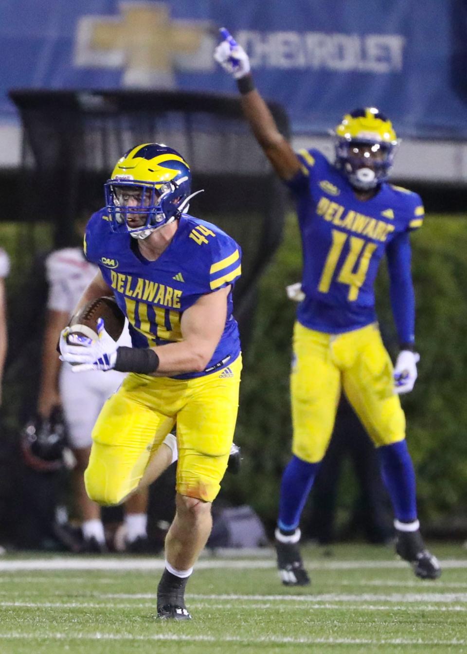 Delaware' linebacker Dillon Trainer takes off with an interception in the fourth quarter of the Blue Hens' 42-14 win against Saint Francis at Delaware Stadium, Saturday Sept. 16, 2023.