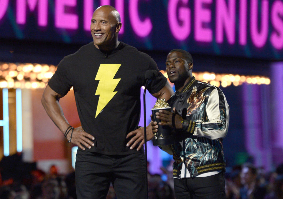 Dwayne Johnson, left, and Kevin Hart present the best comedic genius award at the MTV Movie Awards at Warner Bros. Studio on Saturday, April 9, 2016, in Burbank, Calif. (Kevork Djansezian/Pool Photo via AP)