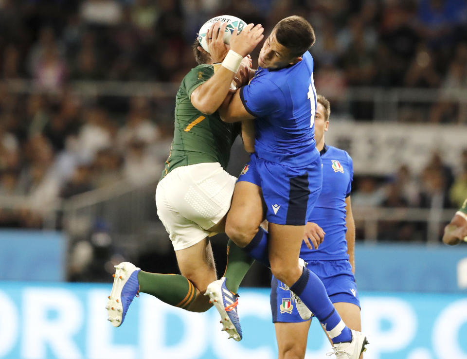 South Africa's Handre Pollard, left, and Italy's Tommaso Allan battle for the ball during the Rugby World Cup Pool B game at Shizuoka Stadium Ecopa between South Africa and Italy, in Shizuoka, Japan, Friday, Oct. 4, 2019. (AP Photo/Shuji Kajiyama)