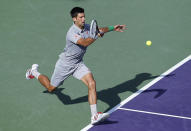 Novak Djokovic, of Serbia, returns the ball to Andy Murray, of Britain, at the Sony Open Tennis tournament in Key Biscayne, Fla., Wednesday, March 26, 2014. Djokovic defeatedMurray 7-5, 6-3. (AP Photo/Joel Auerbach)