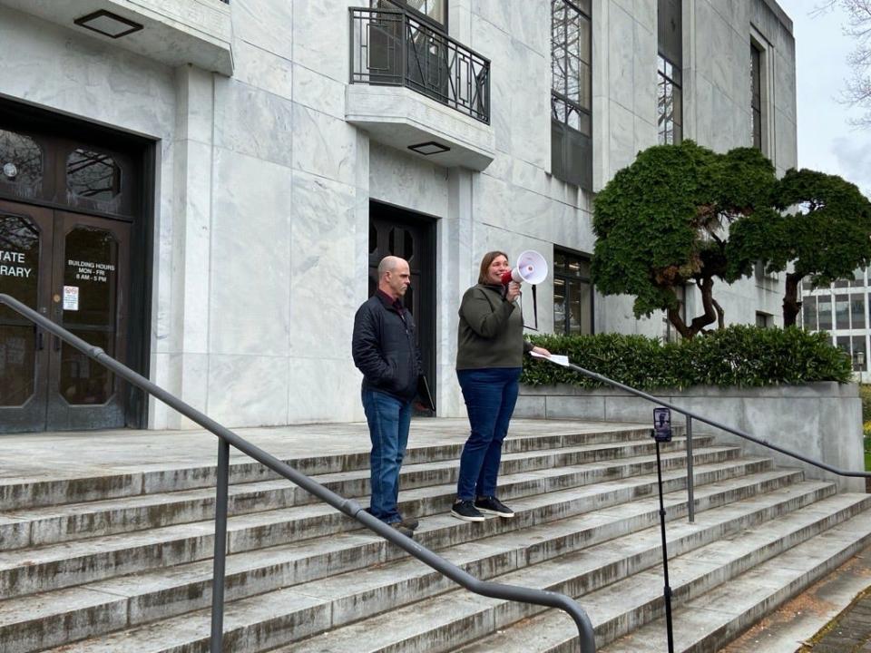 Mike Powers, president of SEIU 503 and Melissa Unger, executive director, speak to workers outside the Oregon State Library on April 4 who were protesting ongoing problems with a new payroll system.