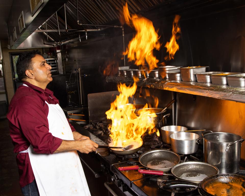 Chef Gurdev Singh mans the stove at Akbar Indian Cuisine in the Pine Plaza Shopping Center in Ocala.