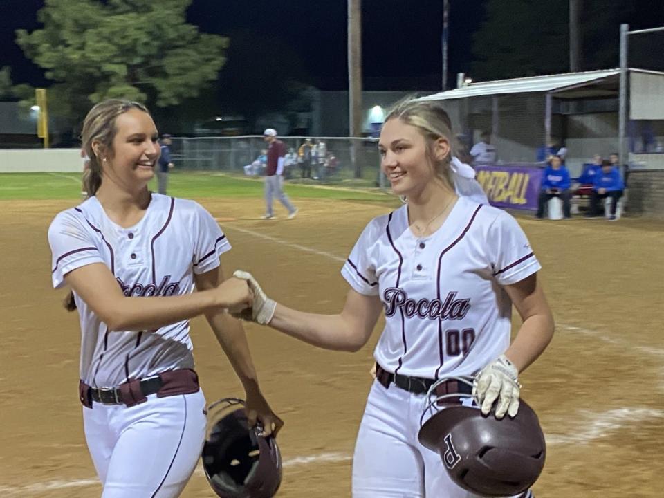 Pocola slow pitch softball player Kail Chitwood (left) celebrates with teammate Allyssa Parker following Parker's fifth inning home run during the LeFlore County Tournament championship Thursday, April 14.