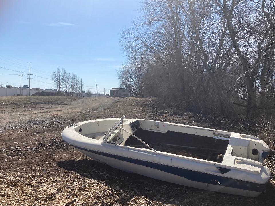 A boat sits on the property just east of the Scioto behind the Great Southern Shopping Center where Metro Parks is working to build the Great Southern Metro Park.