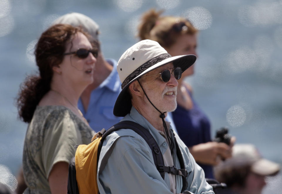 Spectators at Fort Adams State Park watch a match race at the first day of the America's Cup World Series regatta in Newport, RI., Thursday, June 28, 2012. State tourism officials say 7,400 people attended the first day of racing and hope 50,000 people in total will visit the nine-day event, which features four days of racing. (AP Photo/Stephan Savoia)