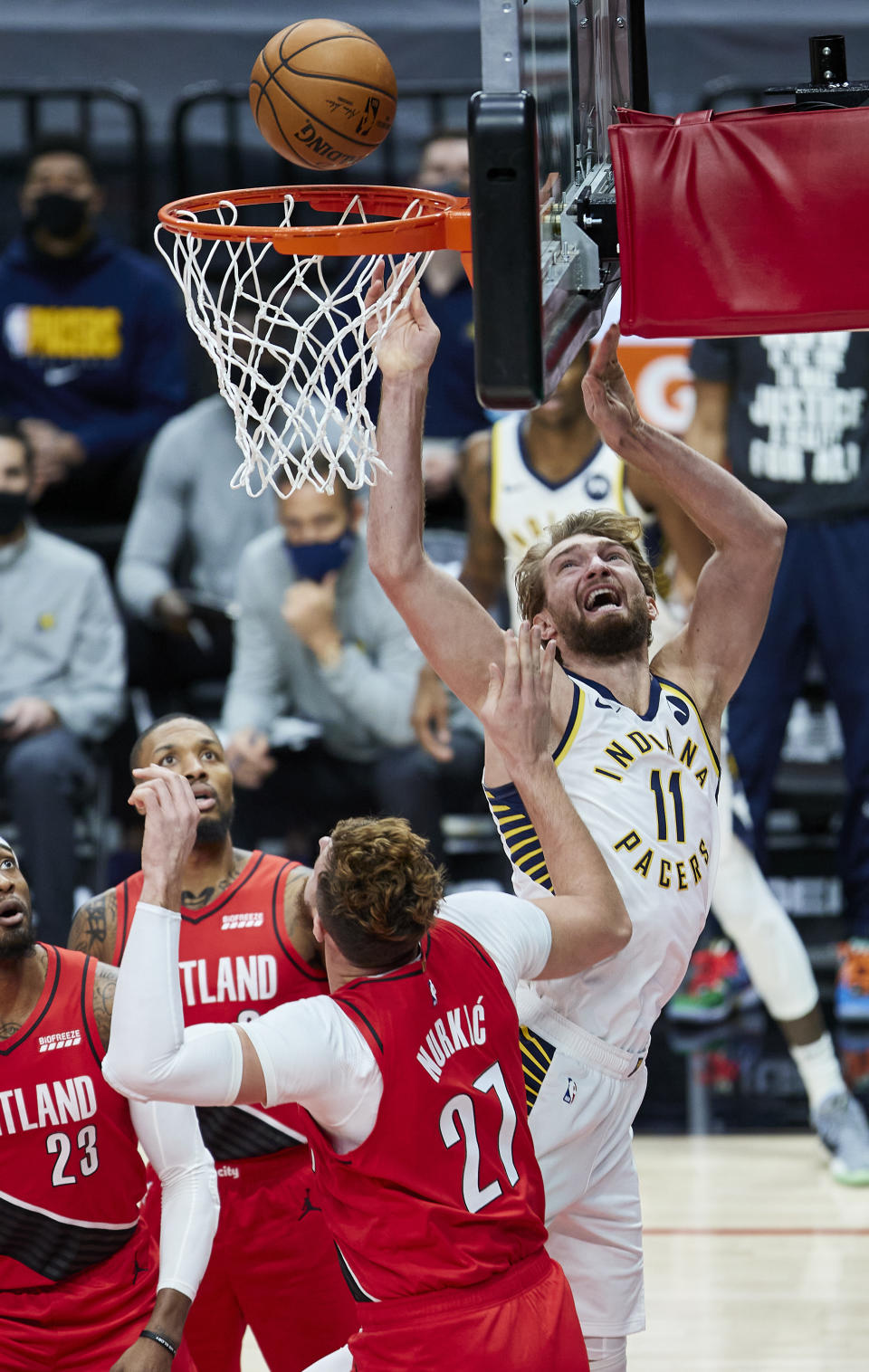 Indiana Pacers forward Domantas Sabonis, right, shoots over Portland Trail Blazers center Jusuf Nurkic during the first half of an NBA basketball game in Portland, Ore., Thursday, Jan. 14, 2021. (AP Photo/Craig Mitchelldyer)