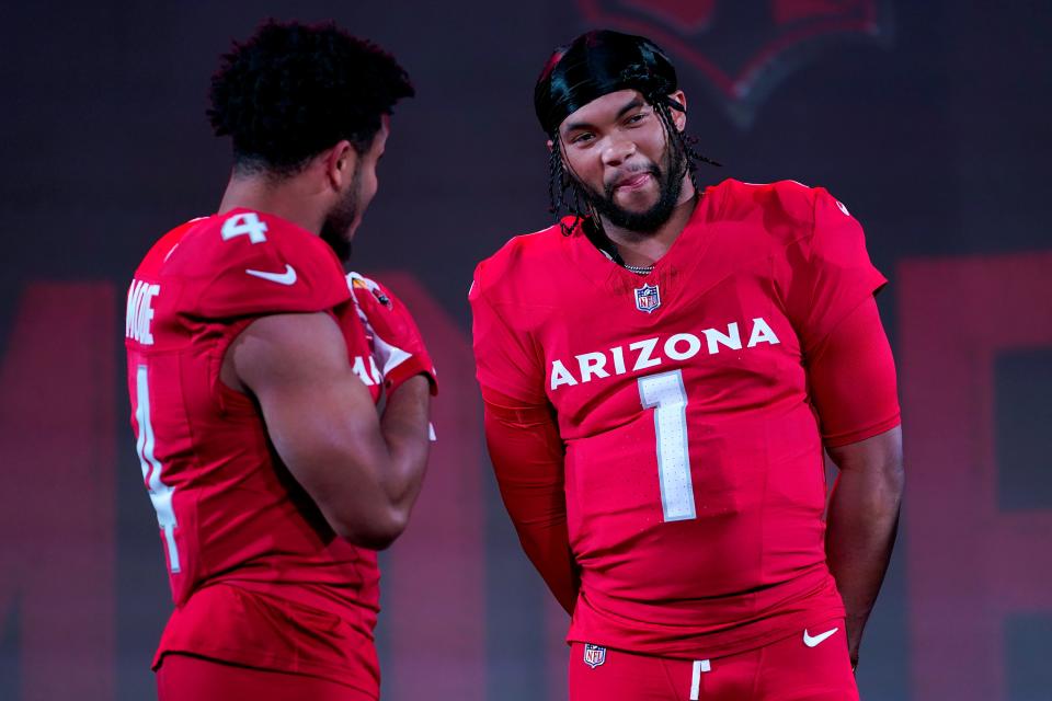 Cardinals QB Kyler Murray (1) and WR Rondale Moore showcase the teams' new uniforms for the 2023 season.