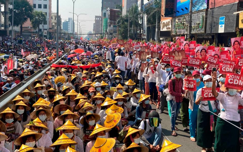 Anti-coup protesters fill the main road during a rally in Mandalay, Myanmar  - AP