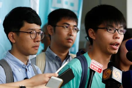 FILE PHOTO: Student leader Joshua Wong (R) speaks to reporters beside Alex Chow (C) and Nathan Law after a verdict, on charges of inciting and participating in an illegal assembly in 2014 which led to the "Occupy Central" pro-democracy movement, outside a court in Hong Kong August 15, 2016. REUTERS/Bobby Yip
