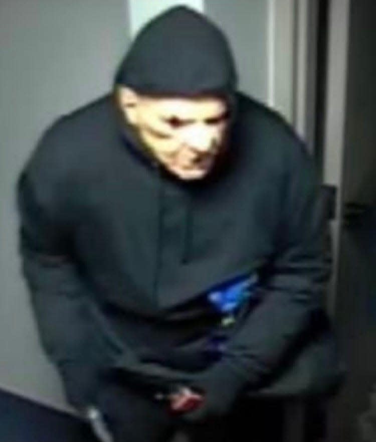 Three armed and masked individuals robbed a Rockland Trust Bank on Nov. 17, 2022, in Tisbury on Martha's Vineyard, according to the police and federal prosecutors. The individuals entered the rear door of the bank wearing dark clothing and masks resembling an older man with exaggerated facial features.
