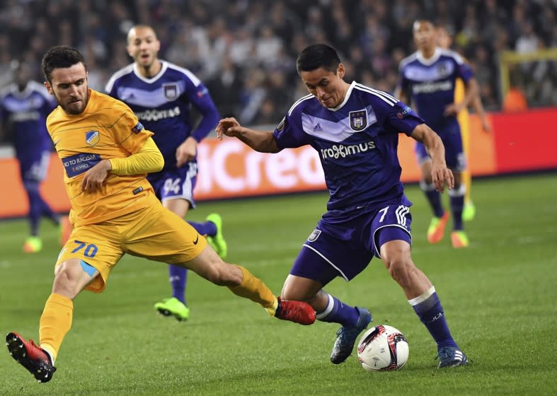 APOEL's Yannis Gianniotas, left, runs after Anderlecht's Andy Najar, second right, during a Europa League round of 16, second leg, soccer match between Anderlecht and APOEL at the Constant Vanden Stock stadium in Brussels, on Thursday, March 16, 2017. (AP Photo/Geert Vanden Wijngaert)