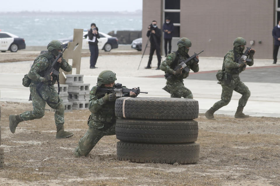 Soldiers perform moving shooting as Taiwan President Tsai Ing-wen inspects at the Penghu Magong military base in outlying Penghu Island, Taiwan, Friday, Dec. 30, 2022. (AP Photo/ Chiang Ying-ying)