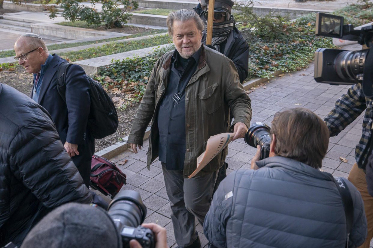 Steve Bannon, center, a longtime ally of former President Donald Trump, convicted of contempt of Congress, arrives at federal court for a sentencing hearing, Friday, Oct. 21, 2022, in Washington. (AP Photo/Nathan Howard)