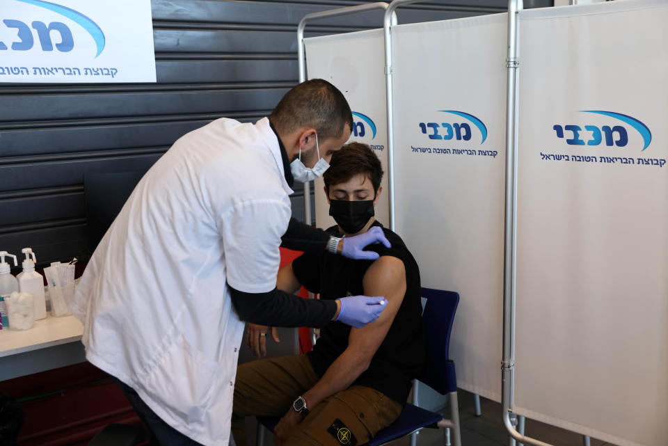 A teenager receives a vaccination against the coronavirus disease (COVID-19), in Tel Aviv, Israel, January 24, 2021. (Ronen Zvulun/Reuters)