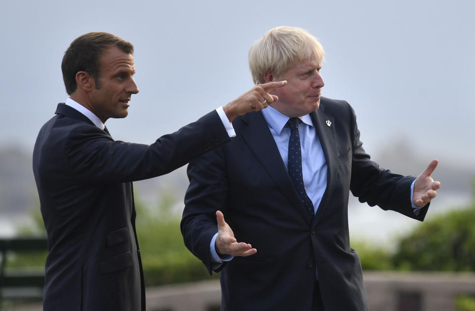 French President Emmanuel Macron speaks with prime Minister Boris Johnson (right) at the official welcome during the G7 summit in Biarritz, France.