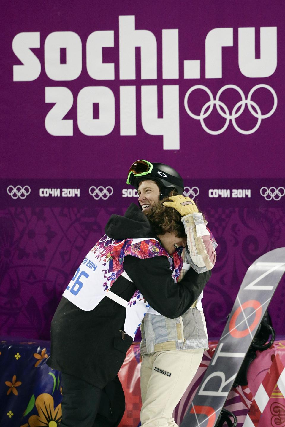 Switzerland's Iouri Podladtchikov, left, celebrates with Shaun White, of the United States, after Podladtchikov won the gold medal in the men's snowboard halfpipe final at the Rosa Khutor Extreme Park, at the 2014 Winter Olympics, Tuesday, Feb. 11, 2014, in Krasnaya Polyana, Russia. (AP Photo/Jae C. Hong, File)