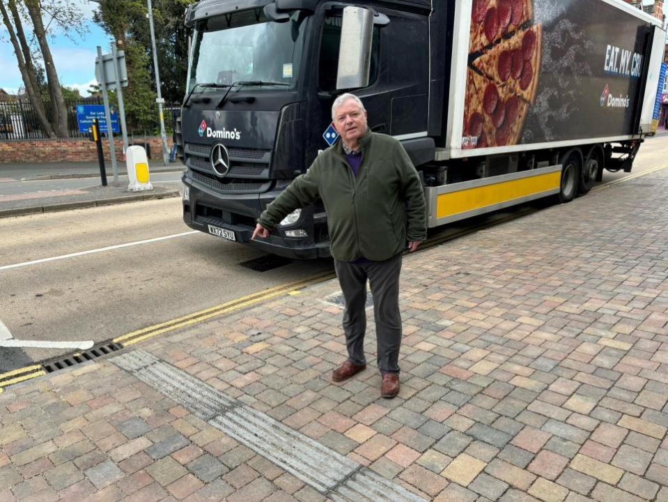 Worcester News: BOLLARDS: Block paving outside Domino's pizza in St John's - Cllr Alan Amos says he is prepared to pay for bollards to stop customers or delivery vans parking there 