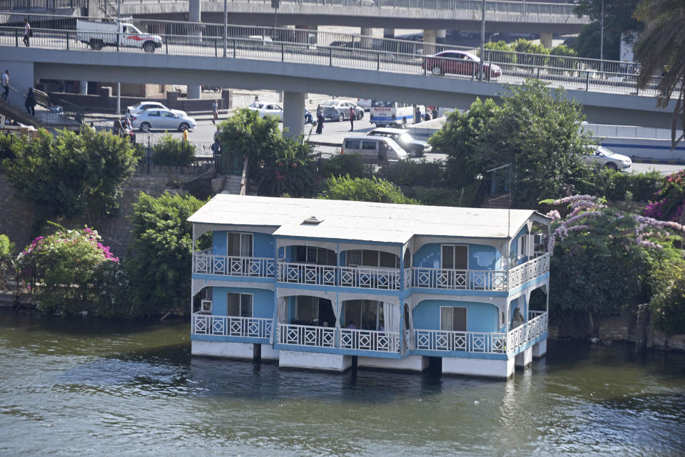 The houseboat belonging to Ikhlas Helmy is seen from the other side of the River Nile on June 27, 2022. A government push to remove the string of houseboats from Cairo’s Nile banks has dwindled their numbers from a several dozen to just a handful. Helmy stands to evicted, and the boat moved or demolished. The tradition of living on the Nile River dates back to the 1800s, and the removal of the boats has drawn criticism in Egypt. The government says it plans to develop the waterfront. (AP Photo/Tarek Wagih)